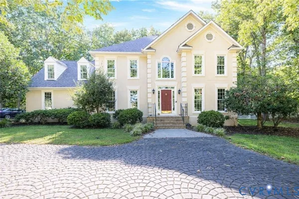 a view of a brick house with a yard