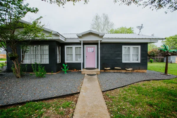 a front view of a house with garden