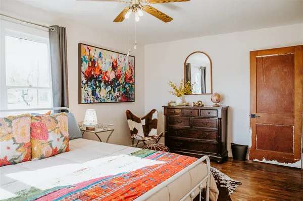 a bedroom with a bed and a painting on the wall