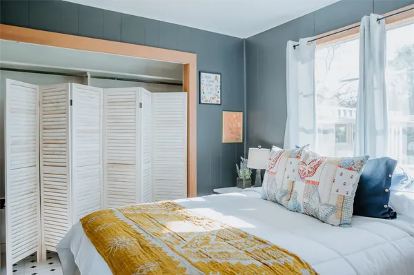 a bedroom with a bed and a window