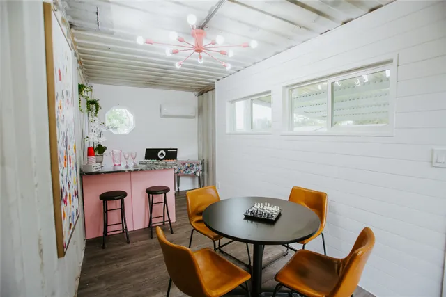a view of a dining room with furniture and a chandelier