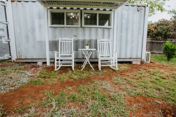a backyard of a house with table and chairs
