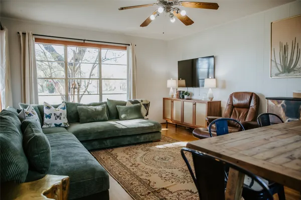 a living room with furniture flat screen tv and a window