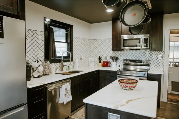 a kitchen with a sink a stove and cabinets