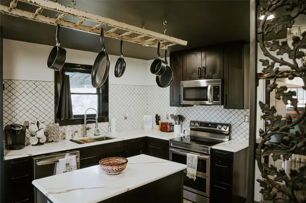 a kitchen with appliances cabinets and furniture