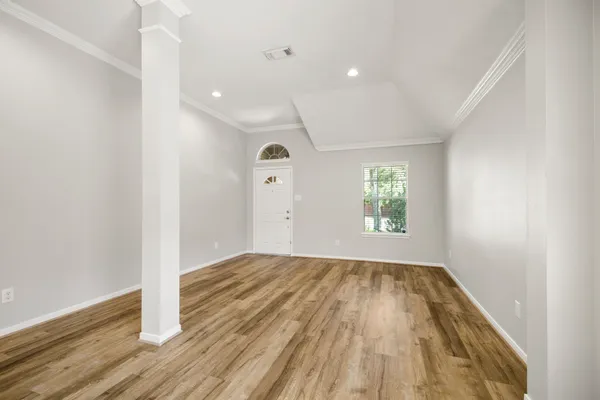 a view of room with window and wooden floor