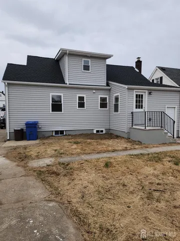 a house that has a large tree in front of it