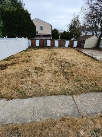 a view of a house with backyard and porch