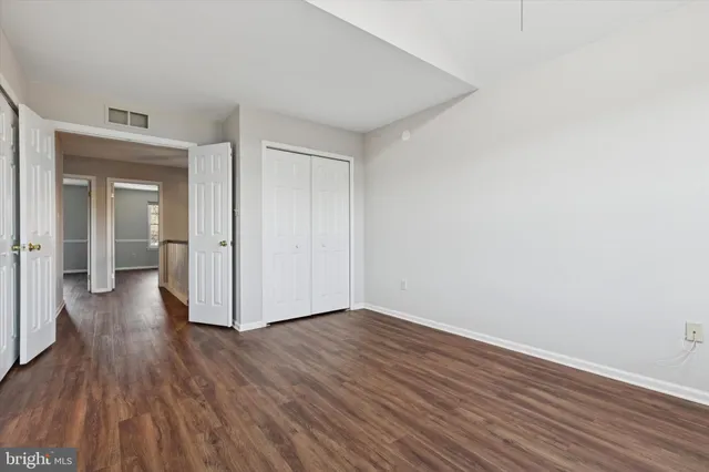 a view of a room with wooden floor
