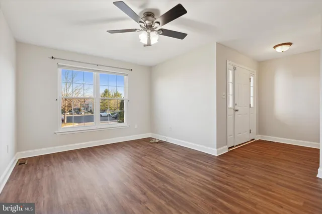 wooden floor in an empty room with a window