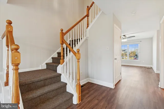 a view of entryway and hall with wooden floor