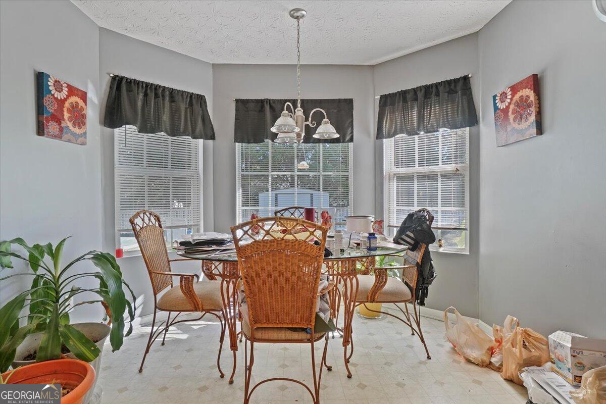915 Harbins View Drive Dacula, GA 30019 - Photo 13 of 26 a dining room with furniture and chandelier