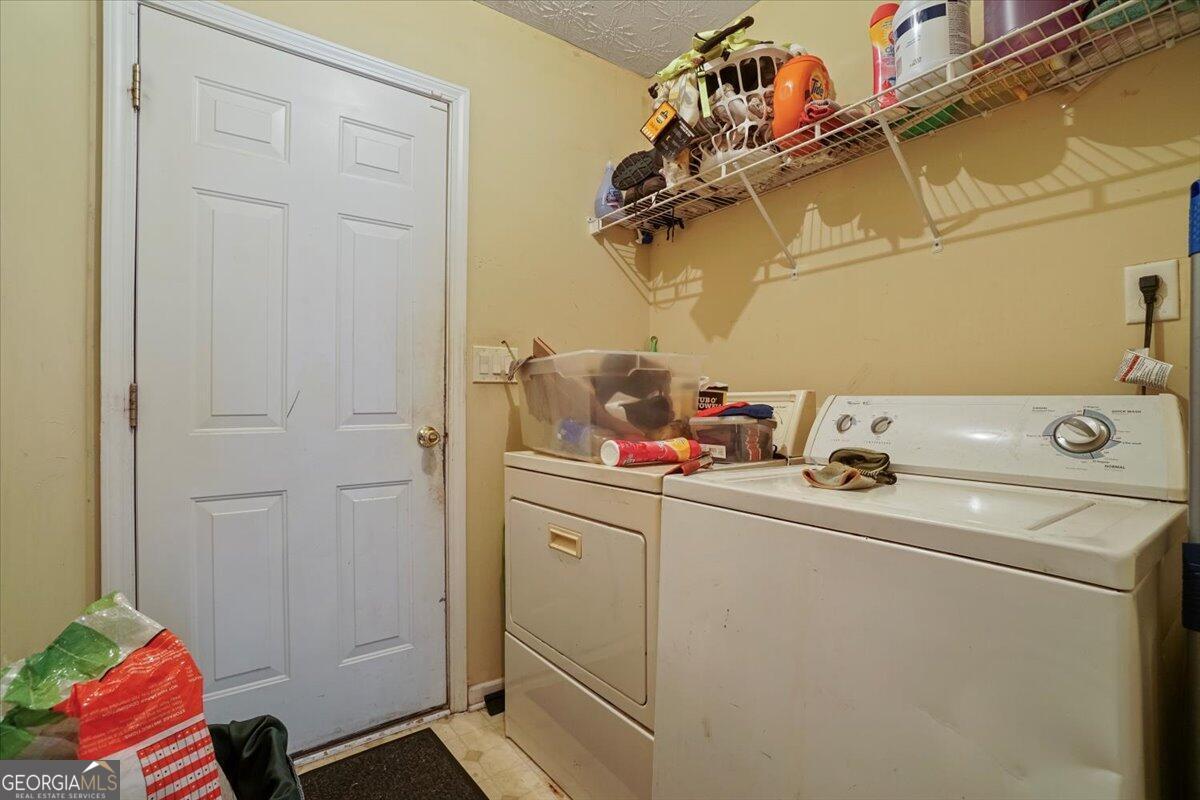 915 Harbins View Drive Dacula, GA 30019 - Photo 19 of 26 a utility room with dryer and washer