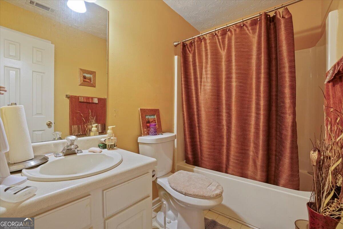 915 Harbins View Drive Dacula, GA 30019 - Photo 21 of 26 a bathroom with a sink toilet and shower