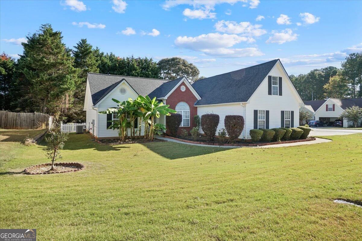 915 Harbins View Drive Dacula, GA 30019 - Photo 3 of 26 a front view of house with yard and swimming pool