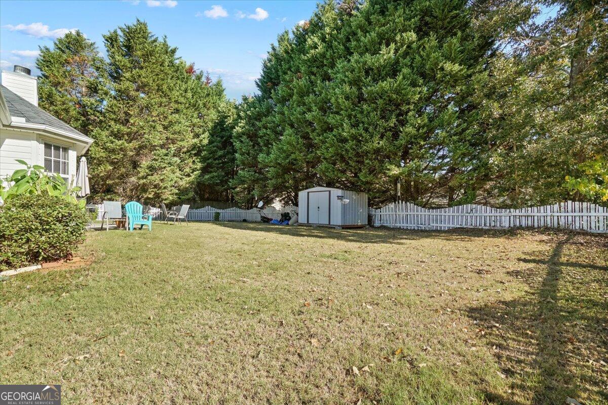 915 Harbins View Drive Dacula, GA 30019 - Photo 7 of 26 a house view with swimming pool in front of it