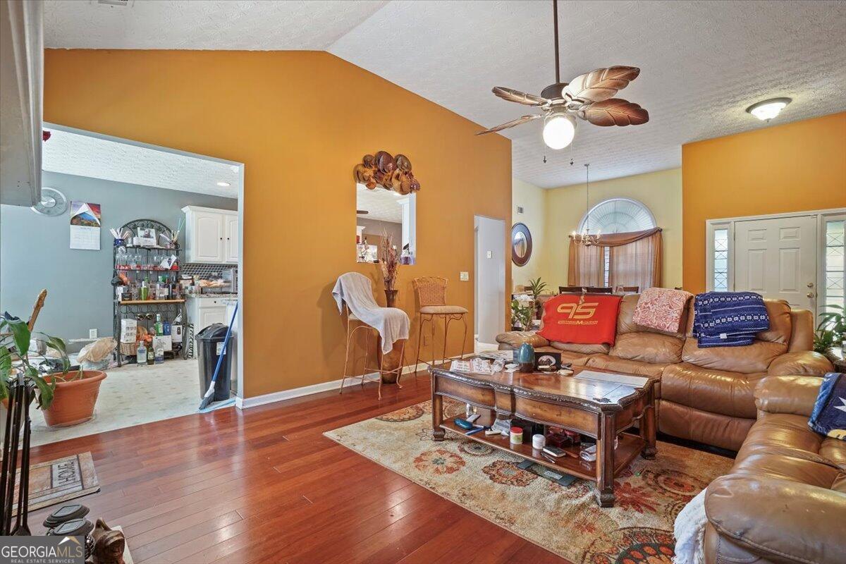 915 Harbins View Drive Dacula, GA 30019 - Photo 10 of 26 a living room with furniture and wooden floor