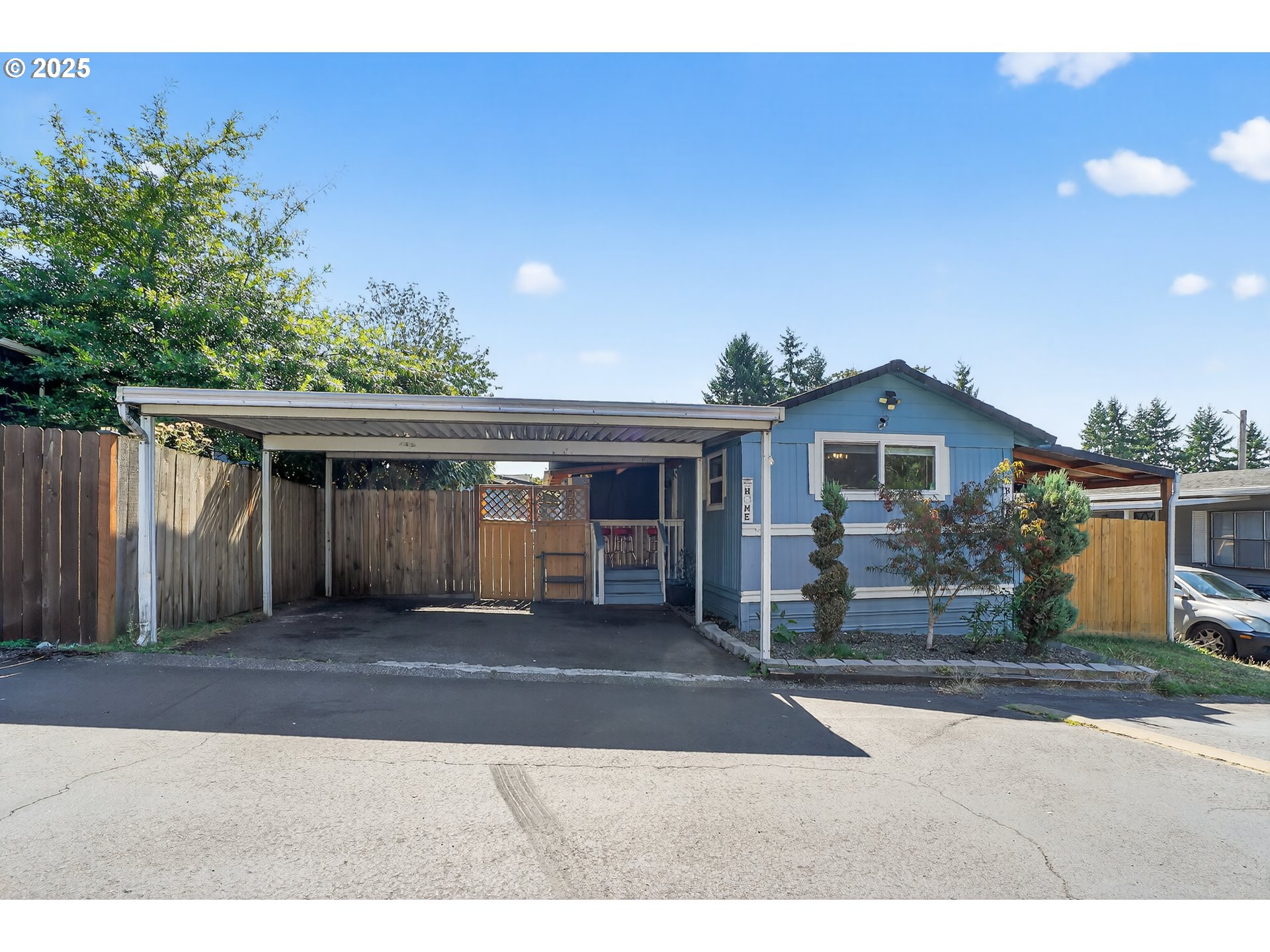 8525 Southeast Orchard Lane, Unit 84 Happy Valley, OR 97086 - Photo 1 of 25 a front view of house with yard and trees in the background