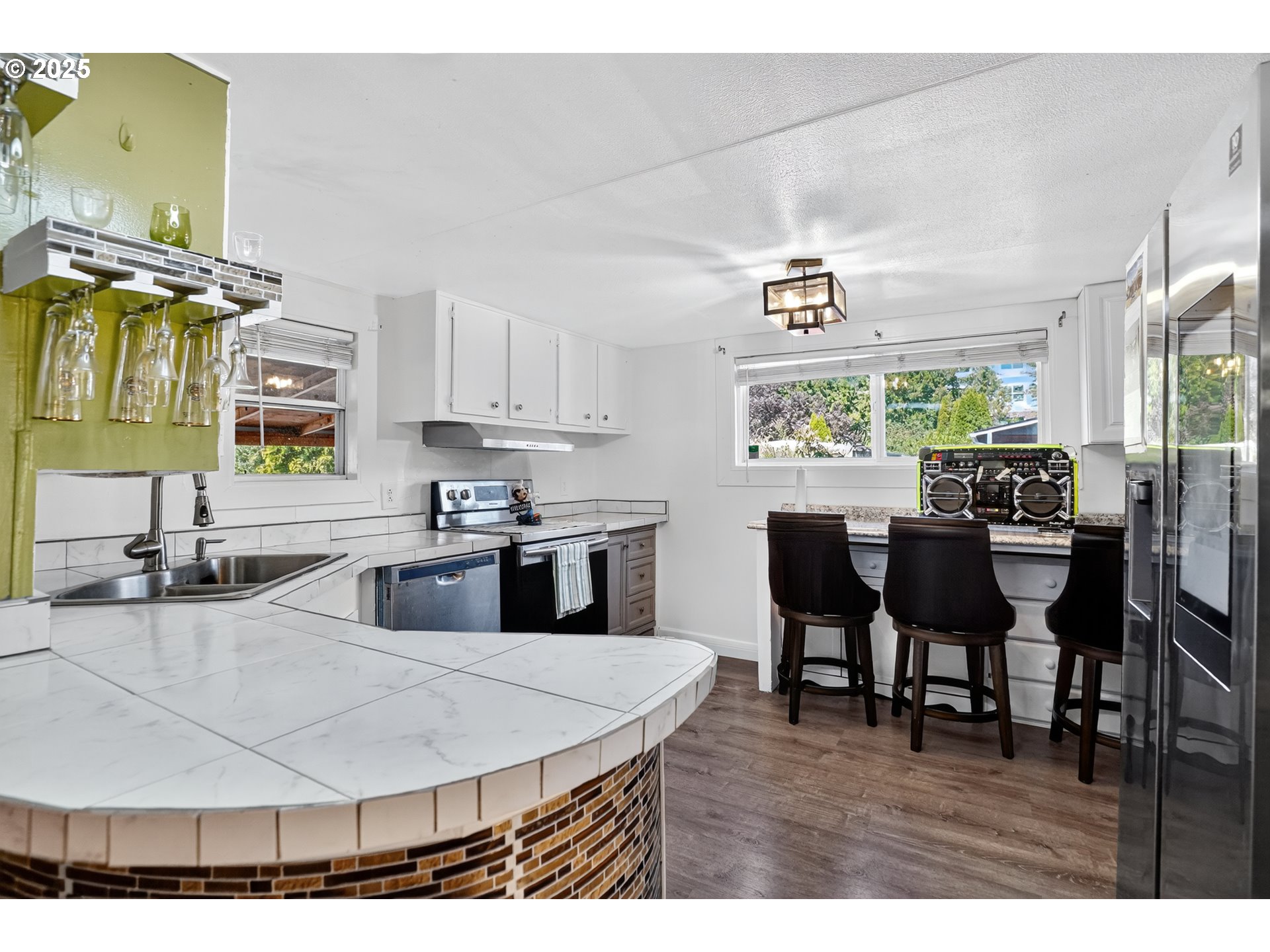 8525 Southeast Orchard Lane, Unit 84 Happy Valley, OR 97086 - Photo 11 of 25 a kitchen with a dining table chairs and window
