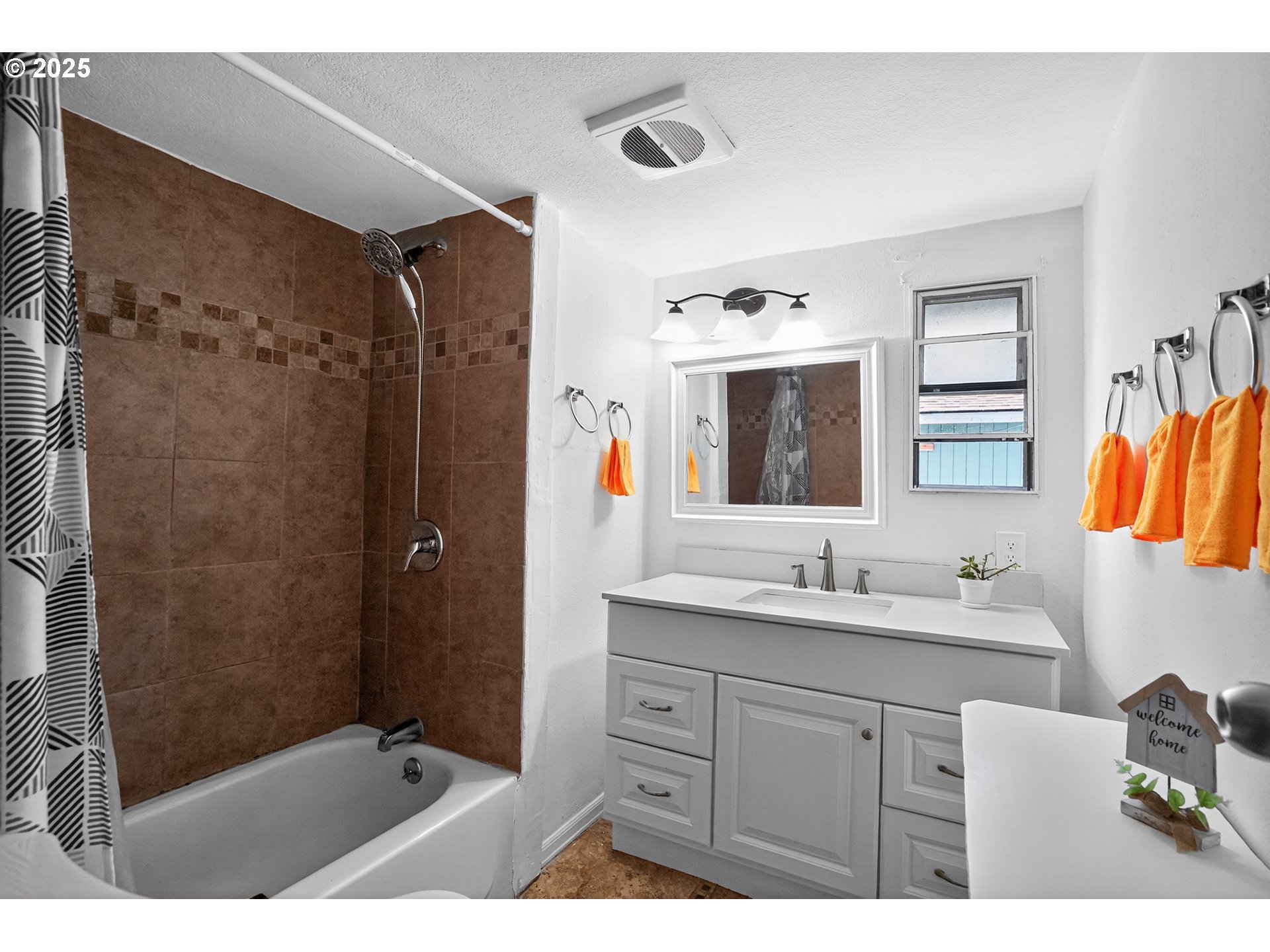 8525 Southeast Orchard Lane, Unit 84 Happy Valley, OR 97086 - Photo 17 of 25 a bathroom with a double vanity sink mirror and shower