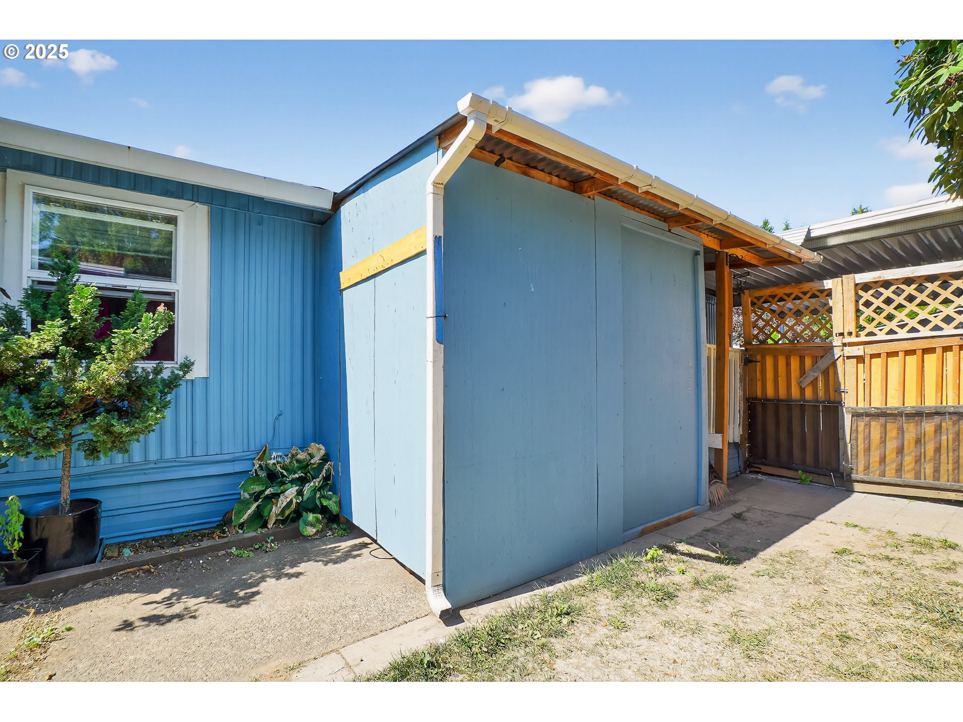 8525 Southeast Orchard Lane, Unit 84 Happy Valley, OR 97086 - Photo 20 of 25 a backyard of a house with potted plants and wooden fence