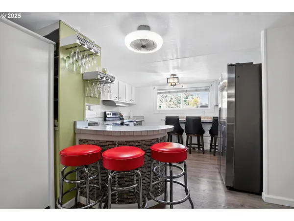 a kitchen with a dining table chairs and window