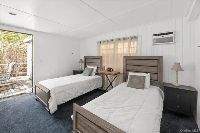 a bedroom with two beds and large window