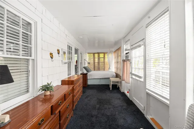 a living room with furniture and large windows