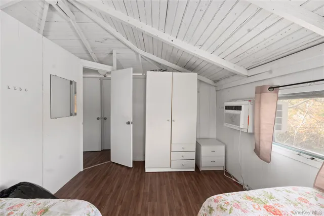 a bedroom with two beds and a chandelier