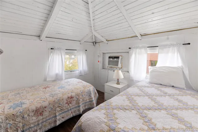 a bedroom with bed and a window