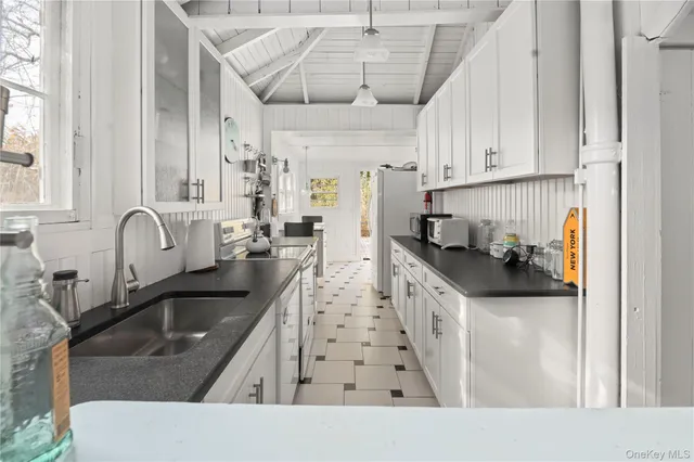 a kitchen with stainless steel appliances granite countertop a sink stove and cabinets