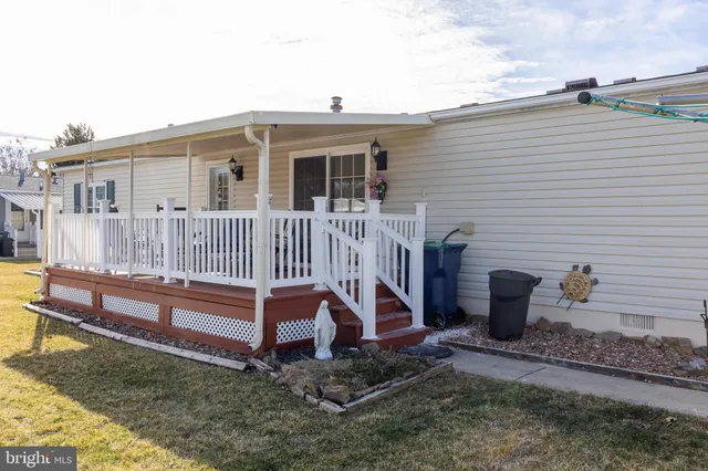 a view of a house with backyard and wooden fence