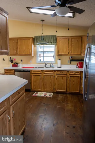 a kitchen with stainless steel appliances granite countertop a sink and cabinets