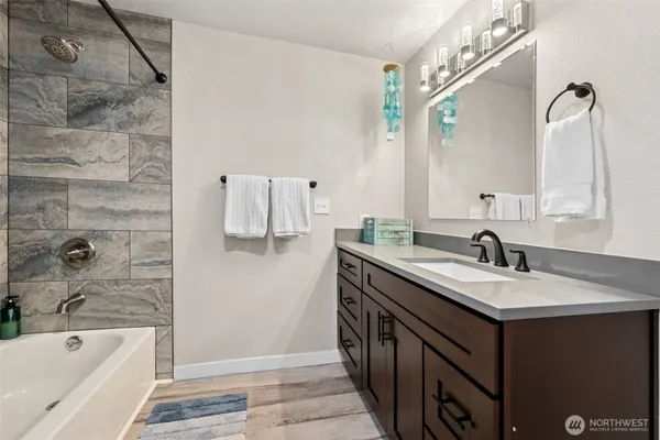a bathroom with a granite countertop sink and a mirror