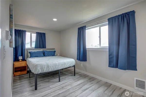 a bedroom with a bed and window