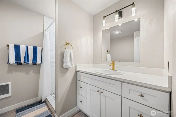 a bathroom with a sink and mirror
