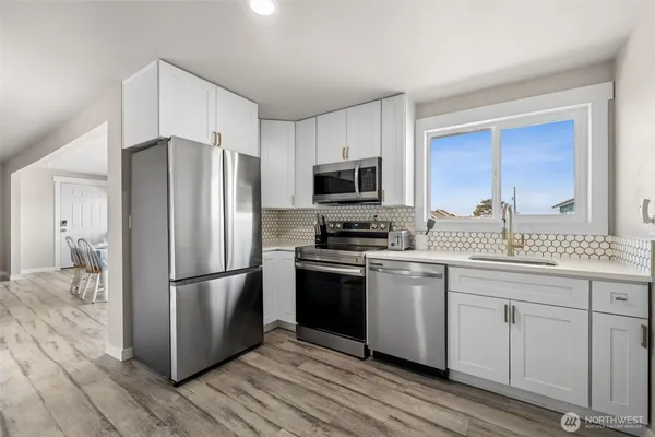 a kitchen with a refrigerator stove and sink