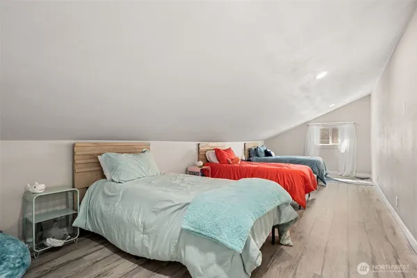 a bedroom with a bed and a night stand