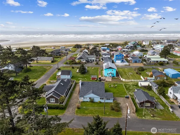 an aerial view of a building with outdoor space and ocean view