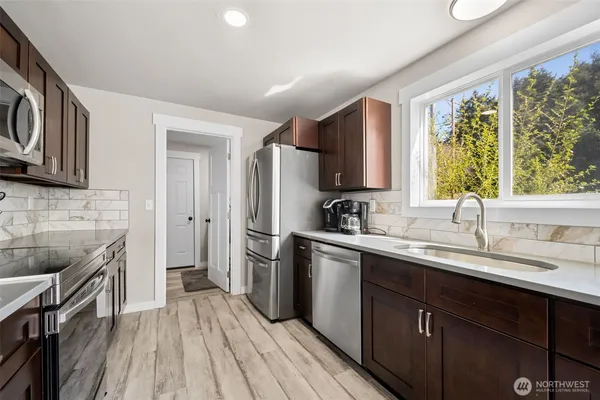 a kitchen with a sink stove and refrigerator