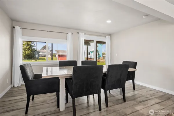 a view of a dining room with furniture window and wooden floor