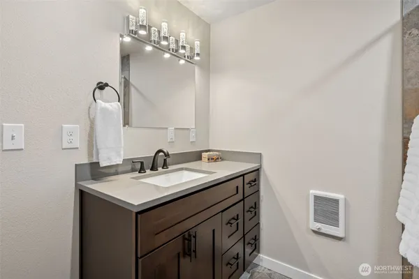 a bathroom with a sink and a mirror