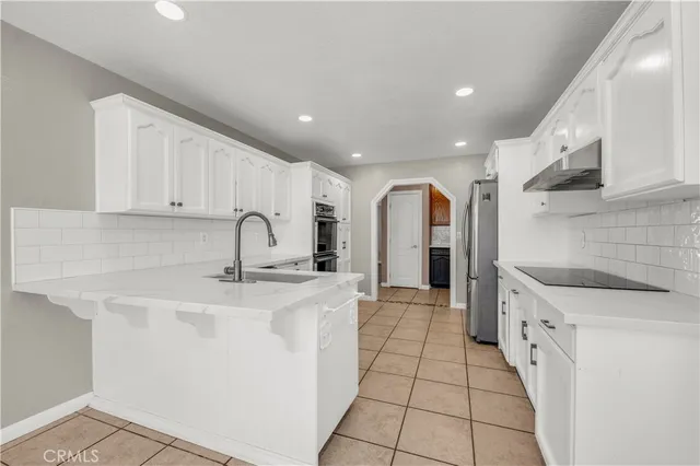 a kitchen with stainless steel appliances granite countertop a sink and cabinets