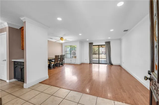 a view of empty room with wooden floor and cabinet
