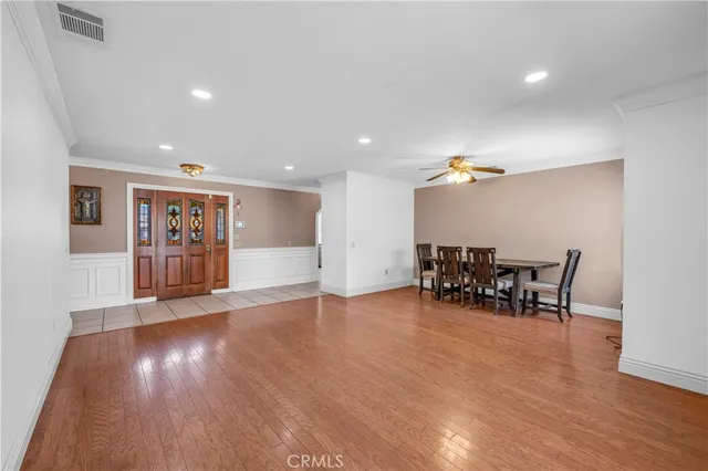 a view of a room with furniture and wooden floor