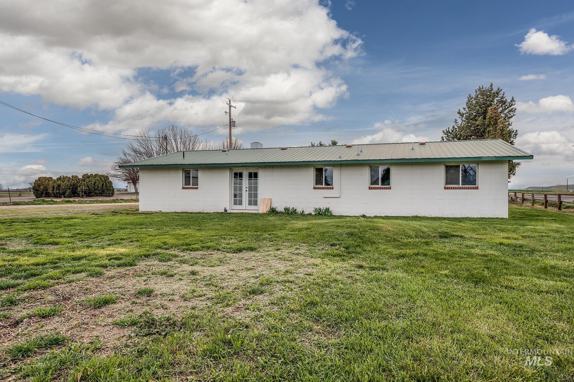 4484 Community Road Ontario, OR 97914 - Photo 34 of 35 Rear view of property with concrete block siding, french doors, and a metal roof