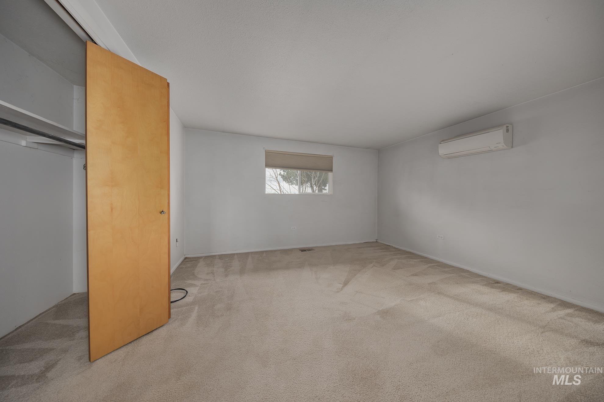 4484 Community Road Ontario, OR 97914 - Photo 10 of 35 Unfurnished bedroom with light colored carpet and a mini split for heating / cooling