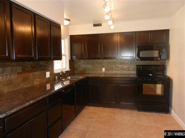 1275 Charles Drive Reno, NV 89509 - Photo 3 of 13 a kitchen with a sink and stainless steel appliances