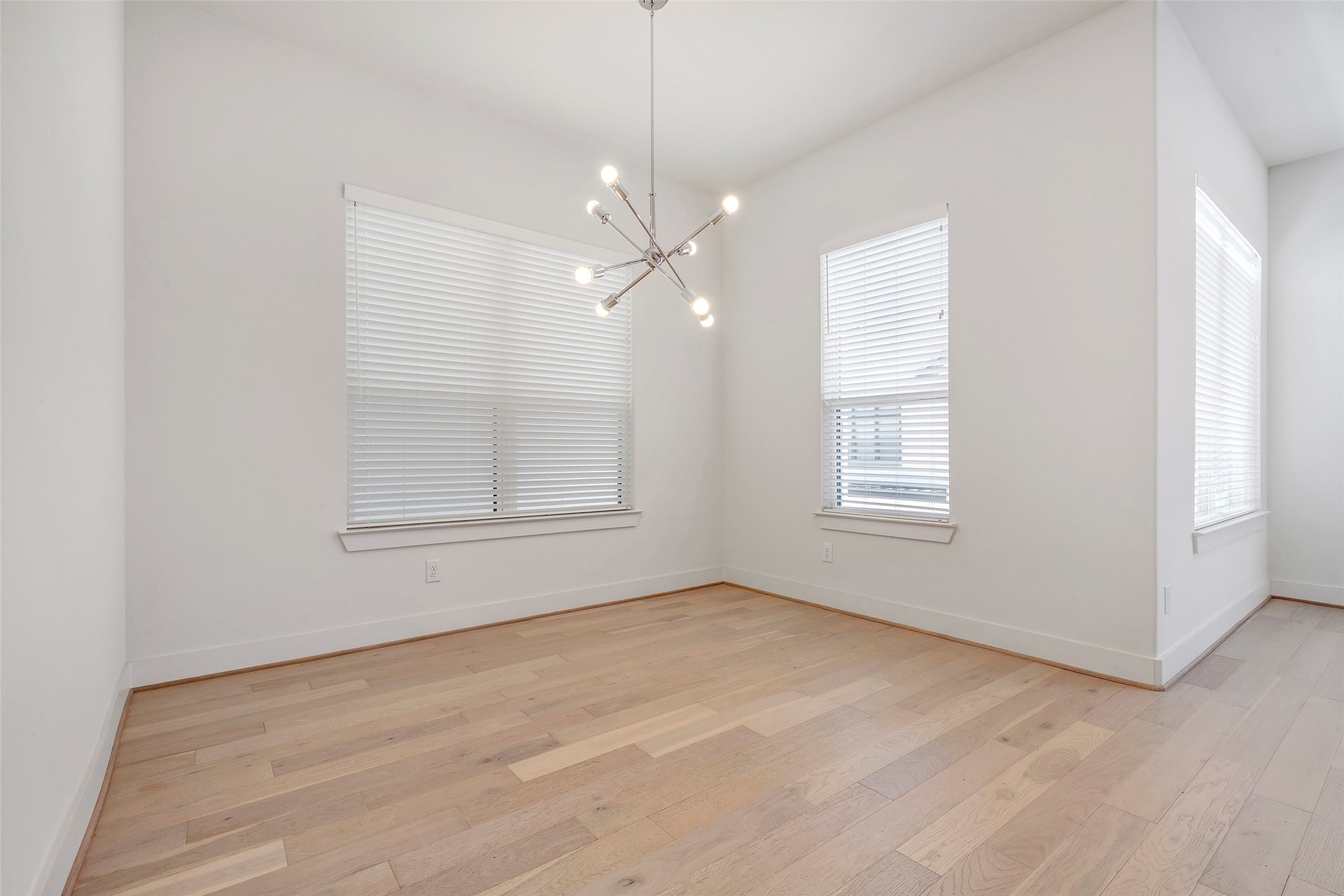 1740 Ojeman Point Lane Houston, TX 77055 - Photo 11 of 20 an empty room with chandelier fan and windows