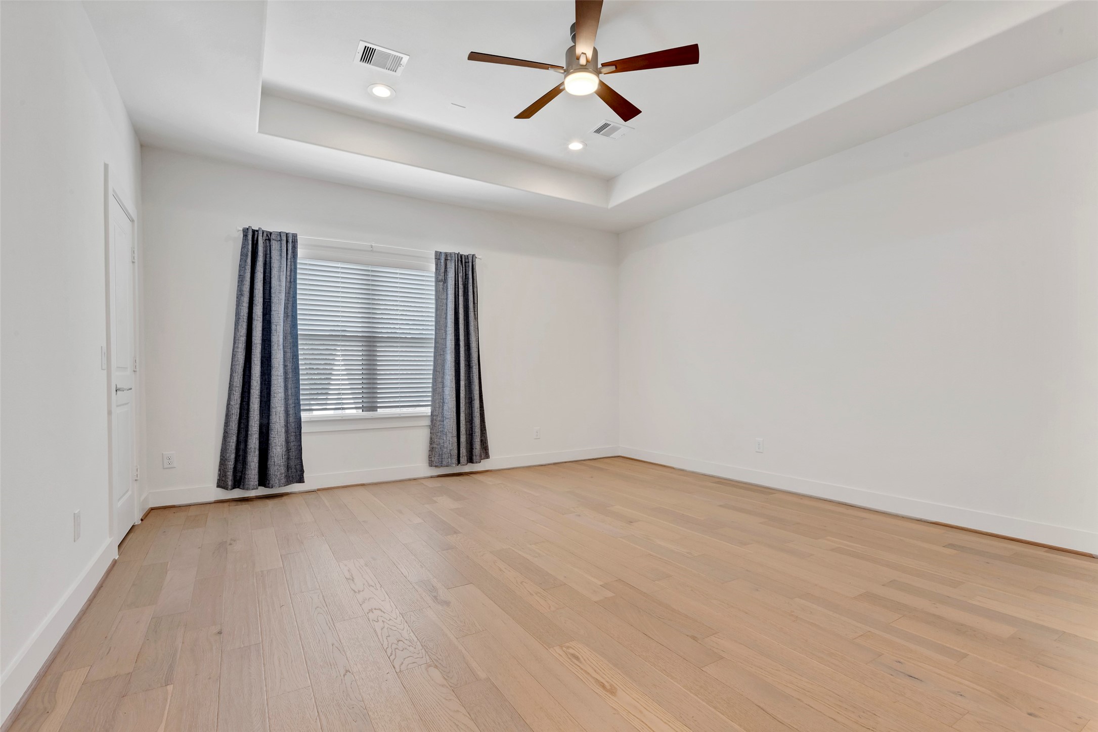 1740 Ojeman Point Lane Houston, TX 77055 - Photo 14 of 20 wooden floor in an empty room with a window